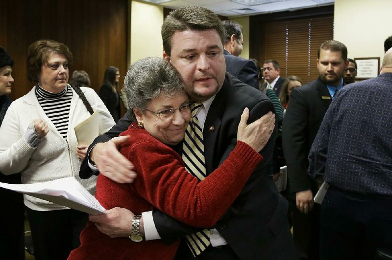 State Sen. Jason Rapert, R-Bigelow, gets a hug from Dorothy Troglin, who supports his bill, approved Tuesday by a House committee, to ban abortion of a fetus if a heartbeat is detectable with an abdominal ultrasound device. 