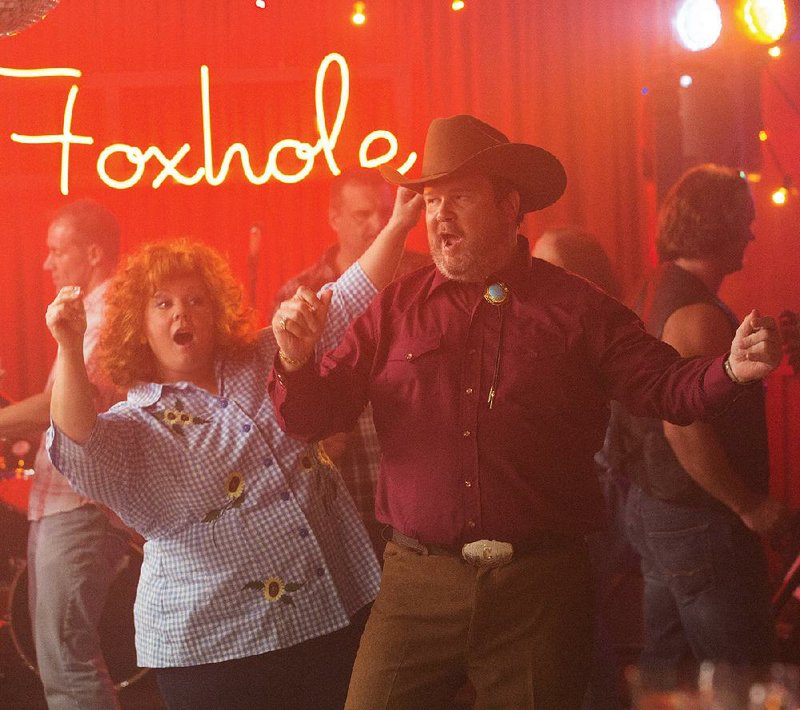 Diana/Sandy (Melissa McCarthy) gets down with Big Chuck (Eric Stonestreet) in Seth Gordon’s Identity Thief. 