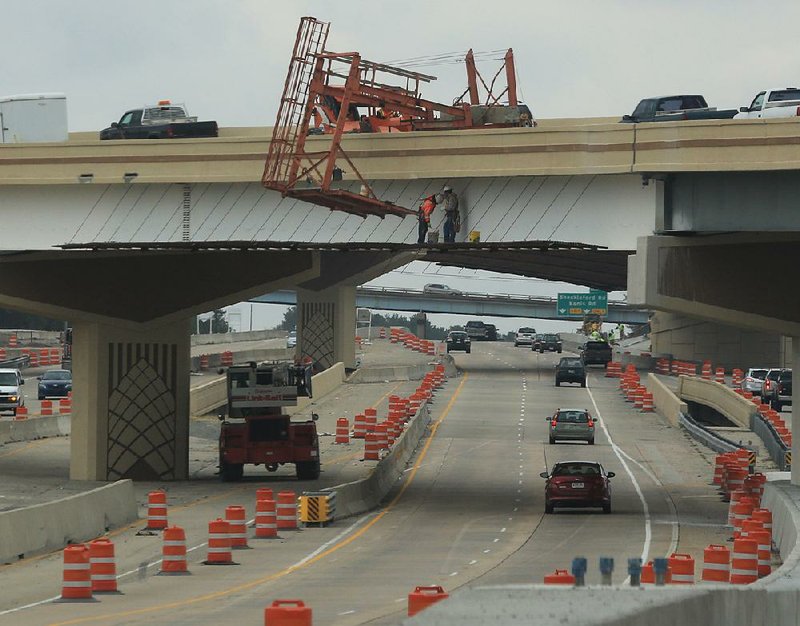 FILE: Workers paint one of the overpasses on Feb. 8 as work continues at the Big Rock interchange at interstates 430 and 630 in west Little Rock. 