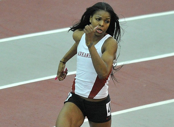 University of Arkansas runner Regina George runs the final turn in the women's 400 M Invitational at the Tyson Invitational track meet at the Randal Tyson Track Complex in Fayetteville.