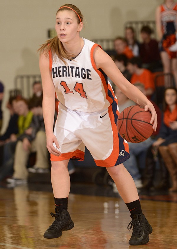 Emilie Jobst of Rogers Heritage looks for a lane to the basket on Feb. 1 during the Lady War Eagles’ game against Fayetteville at War Eagle Arena in Rogers. 