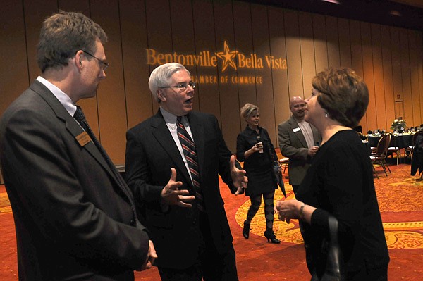 Dana Davis, second from left, incoming chamber president chats Thursday with Tom Ginn, left and Bootsie Ackerman at the annual Bentonville/Bella Vista Chamber of Commerce dinner. Ginn is with the chamber and Ackerman works for 3rd District Rep. Steve Womack, R-Rogers. 