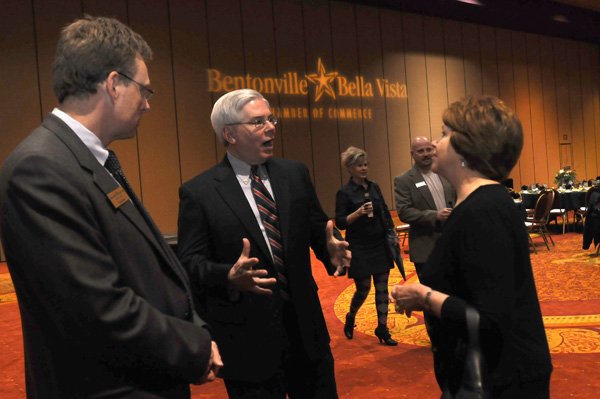 Dana Davis, second from left, incoming chamber president chats Thursday with Tom Ginn, left and Bootsie Ackerman at the annual Bentonville/Bella Vista Chamber of Commerce dinner. Ginn is with the chamber and Ackerman works for 3rd District Rep. Steve Womack, R-Rogers. 
