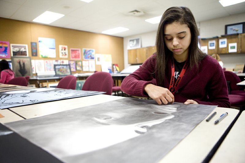 Nicky Grandison works on a charcoal drawing during Marvin Lindley’s art class at Jacksonville High School. Grandison is one of several students who will have work featured in an upcoming art show.