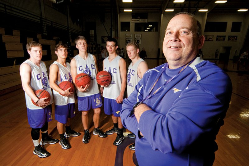 CAC basketball coach Steve Quattlebaum is shown with five seniors — Dylan Sherrill, from the left, Beau Barnes, Josh Holland, Travis Byrne and Logan Stafford — who were playing when Quattlebaum transitioned from being the girls coach in 2010.