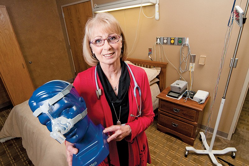 Susan O’Nale, manager of the sleep disorder center at National Park Medical Center, shows a nasal CPAP (continuous positive airway pressure) unit in one of the sleep labs.