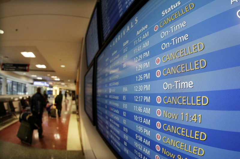 TV monitors at Logan International Airport in Boston show cancelled flights Friday morning, Feb. 8, 2013. 