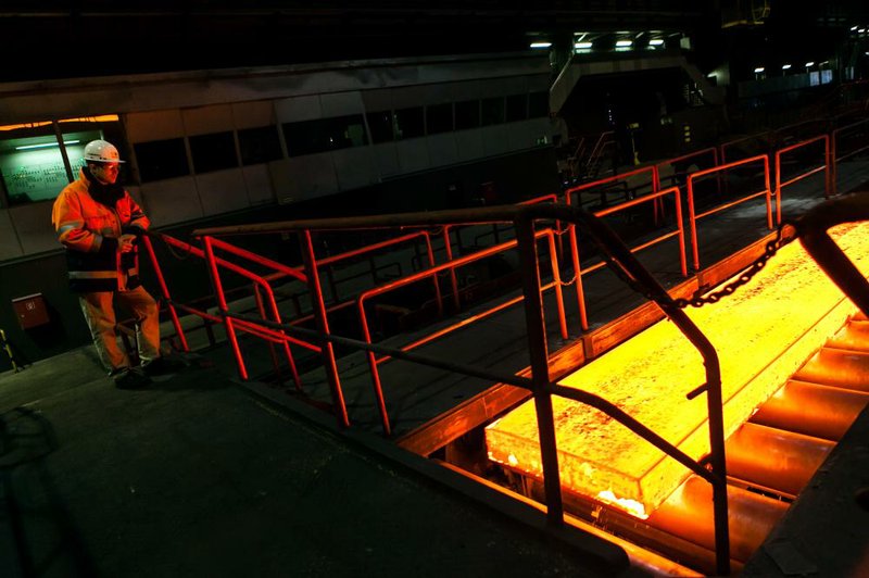 A slab of steel moves along a production line during the “hot rolling” process at ThyssenKrupp AG’s steel mill in Duisburg, Germany. ThyssenKrupp said Friday it plans to cut more than 2,000 jobs in Europe. 