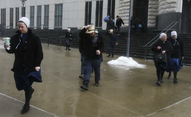 Amish men and women leave the federal courthouse in Cleveland on Friday after sentencing in a rash of hair-cutting attacks. 