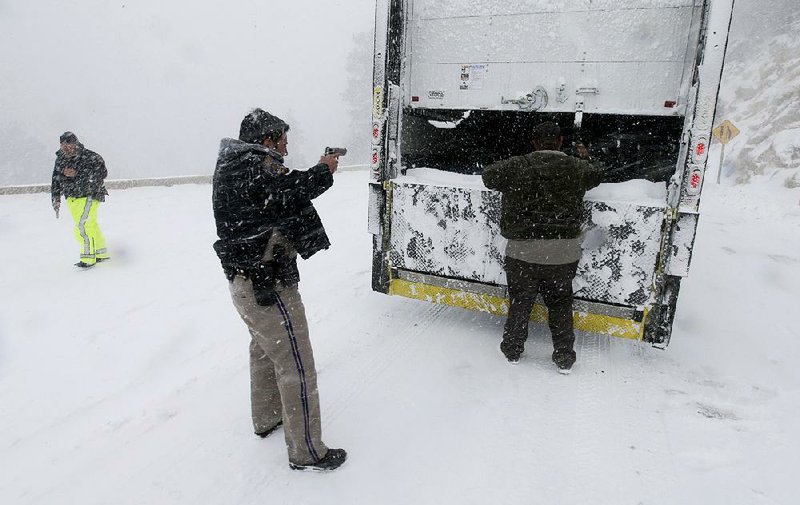 Members of the California Highway Patrol search a truck Friday in Big Bear Lake, Calif., for Christopher Dorner, a former Los Angeles police officer accused of going on a killing rampage because he felt he was unfairly fired from his job. 