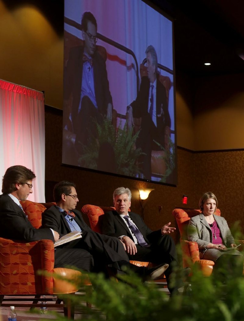 J.B. Hunt’s John Roberts III (from left), Adolfo Laurenti of Mesirow Financial, Christopher Waller of the Federal Reserve Bank of St. Louis and University of Arkansas economist Kathy Deck discuss economics Friday. 