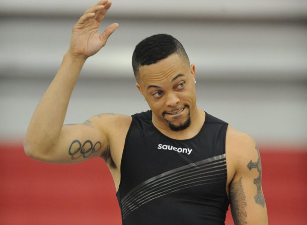 Former Arkansas sprinter Wallace Spearmon acknowledges the crowd before the start of his section of the 200 meters Saturday, Feb. 9, 2013, during the Tyson Invitational at the Randal Tyson Track Center in Fayetteville.