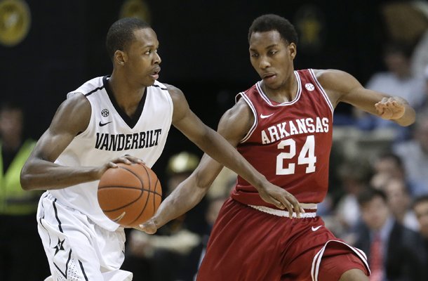 Vanderbilt forward Rod Odom, left, drives against Arkansas guard Michael Qualls (24) during the first half of an NCAA college basketball game Saturday, Feb. 9, 2013, in Nashville, Tenn. (AP Photo/Mark Humphrey)