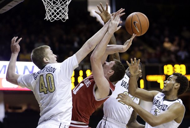 Arkansas forward Hunter Mickelson, second from left, loses the ball as he tries to shoot among Vanderbilt defenders Josh Henderson (40), Dai-Jon Parker (24) and Kevin Bright, right, during the first half of an NCAA college basketball game on Saturday, Feb. 9, 2013, in Nashville, Tenn. (AP Photo/Mark Humphrey)