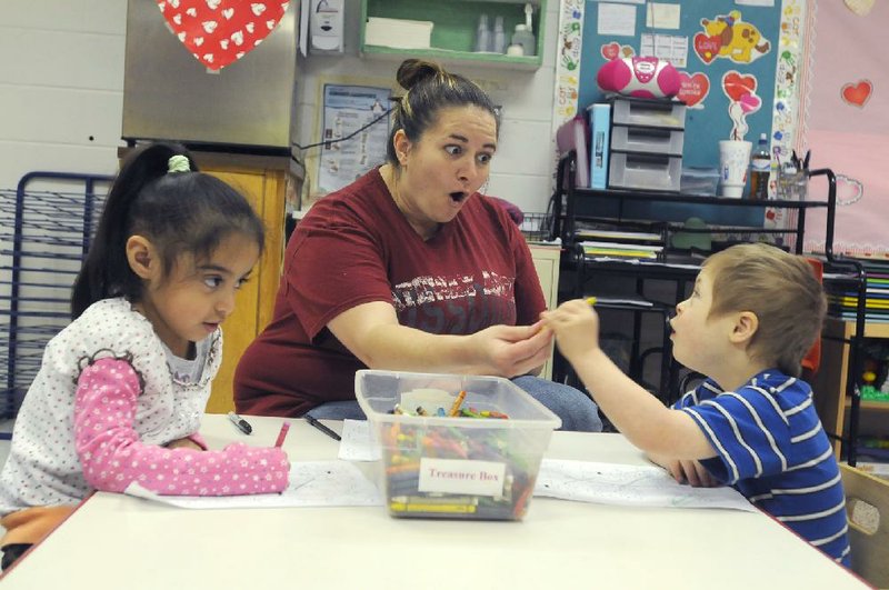 NWA Media/ANTHONY REYES
Danielle McCranie, center, classroom instructor plays with Yanille Galvan, 4, left, and Andrew Cairns, 5, Friday, Feb. 8, 2013 at the Elizabeth Richardson Center preschool next to Woodland Junior High School in Fayetteville. The Elizabeth Richardson Center is celebrating its 50th anniversary.