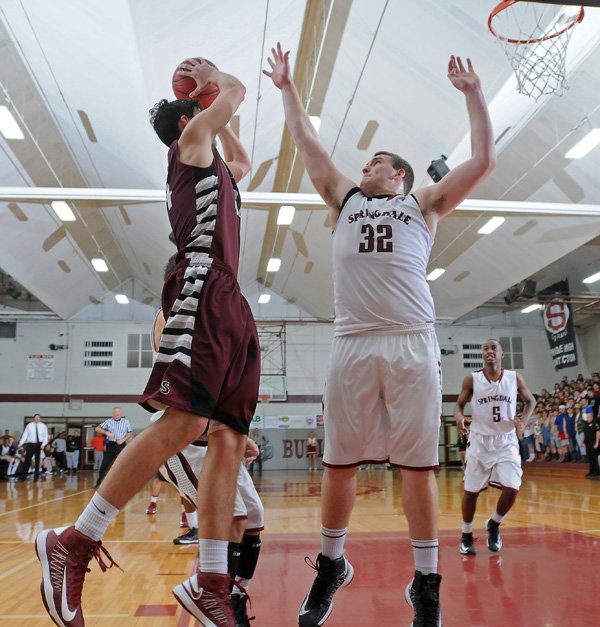 Josiah Wymer, right, of Springdale High tries to block the shot by Siloam Springs’ Payton Henson on Friday in Springdale.