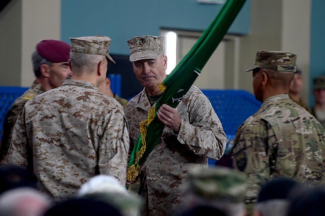 Marine Gen. Joseph Dunford receives a flag from Marine Gen. John Allen (left) after taking over as new commander of NATO forces in Afghanistan during a change-of-command ceremony Sunday in Kabul. 