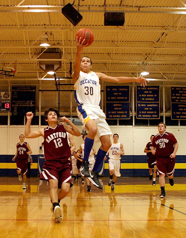 Decatur senior forward Andrew Harris breaks away from Hartford's Brody Funk and puts the ball up for two during play on January 25th at Decatur High School.