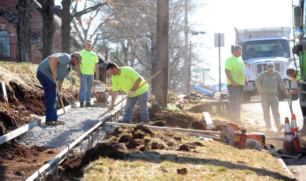 Transportation Division workers build a new sidewalk Tuesday on the east side of Willow Avenue between Lafayette and Maple streets. 