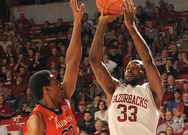 Arkansas junior Marshawn Powell shoots as Auburn senior Noel Johnson (32) defends him, Jan. 16, 2013 in Bud Walton Arena in Fayetteville. The Razorbacks beat the Tigers 88-80 in double overtime.