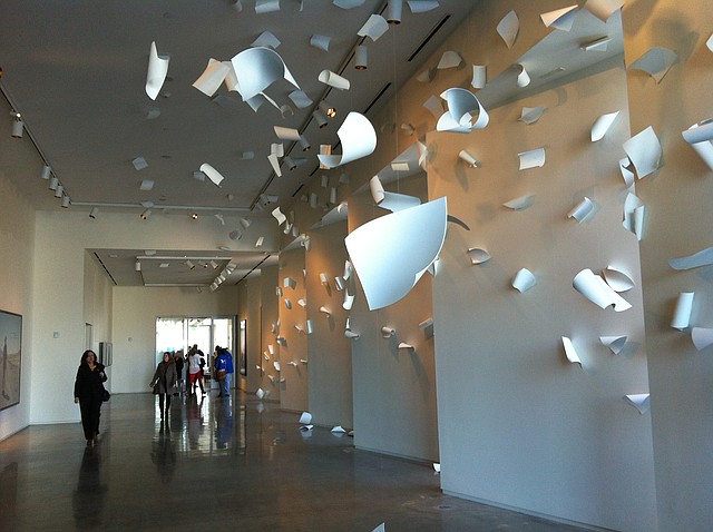 Attendees of the 21c Museum Hotel walk past "A Sudden Gust of Wind" by Serkan Ozkaya on Monday. 