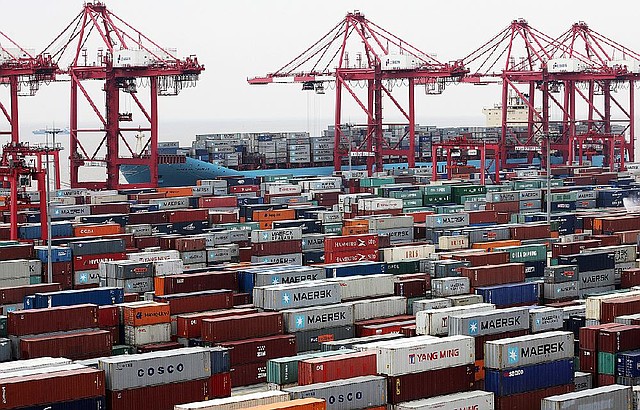 Shipping containers are stacked at the Yangshan Deep Water Port in Shanghai, China, on Jan. 31. Last month, China’s trade expanded with exports rising 25 percent from a year earlier and imports increasing 28.8 percent, according to government data released Friday. 