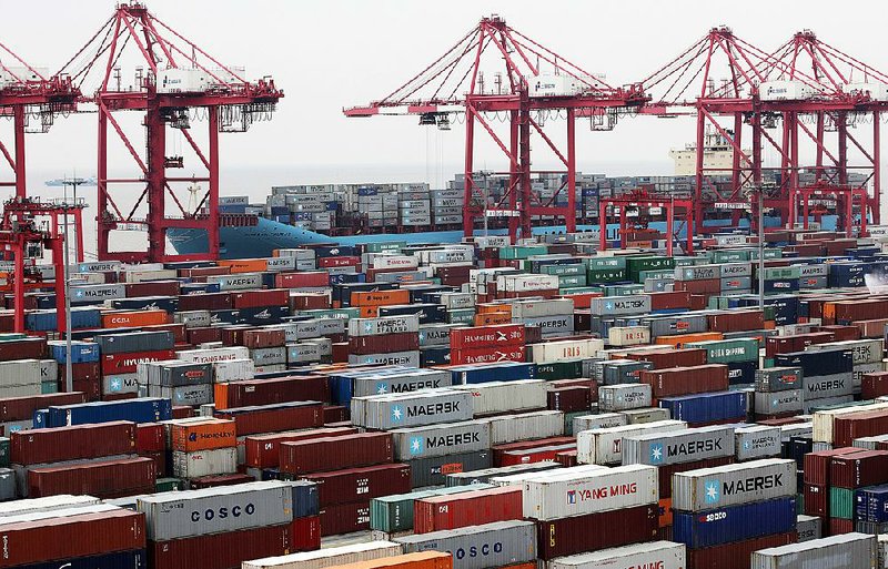 Shipping containers are stacked at the Yangshan Deep Water Port in Shanghai, China, on Jan. 31. Last month, China’s trade expanded with exports rising 25 percent from a year earlier and imports increasing 28.8 percent, according to government data released Friday. 