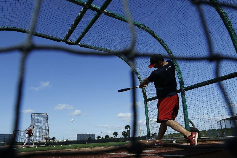 St. Louis Cardinals first baseman Matt Carpenter takes a swing at a pitch from pitcher Dennis Schutzenhofer on Monday in Jupiter, Fla. Major league pitchers and catchers reported to spring training at camps in Arizona and Florida on Monday. The 2013 season begins March 31 when the Texas Rangers visit the Houston Astros in Houston. Beginning this season, the American and National leagues will feature 15 teams each, with the Astros moving to the AL West after playing in the NL since 1962.


