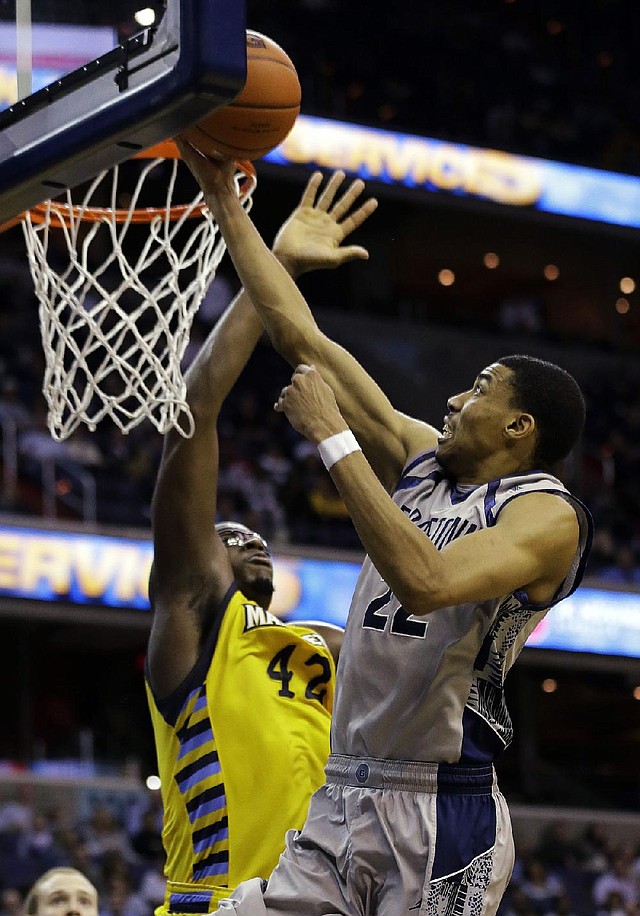 Georgetown forward Otto Porter Jr. (22) shoots over Marquette center Chris Otule (42) during the second half of Monday’s game in Washington. Porter had 21 points as Georgetown won 63-55. 