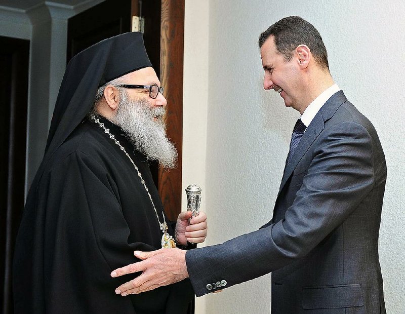 Syrian President Bashar Assad receives Patriarch John Yazigi, the Eastern Orthodox Patriarch of Antioch and All the East, in Damascus, Syria, on Monday. 