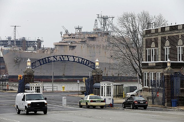 Vehicles pass the main gate at Philadelphia’s Navy Yard last week. The former military property is now home to 130 companies and 10,000 employees. 