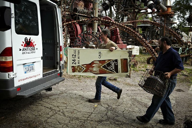 2013 FILE PHOTO: American Pickers' "modern archeologists" Mike Wolfe (left) and Frank Fritz load up their latest finds destined for a collector or lover of antiques.
