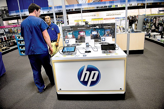 A shopper looks at a display of Hewlett-Packard Co. tablet computers at a Best Buy store in East Palo Alto, Calif. Autonomy Corp., a software company Hewlett-Packard bought in 2011, is being audited by England’s accounting regulator. 