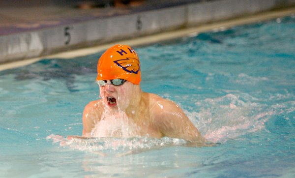 Rogers Heritage’s Ian Pusey swims in the 100 breaststroke on Jan. 31 during the Bentonville Invitational Meet. 