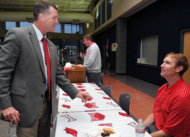 Sean Rochelle (left), pictured in this 2009 file photo with former Arkansas basketball coach John Pelphrey, has worked with the Razorback Foundation since 2008. 