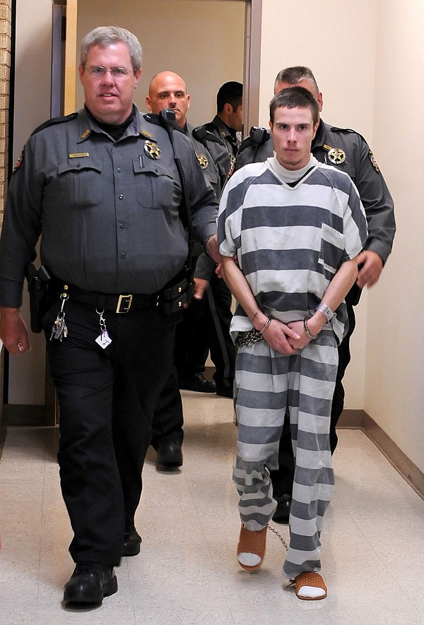 Zachary Holly is escorted to court Nov. 28 for arraignment on charges related to the death of 6-year-old Jersey Bridgeman at the Benton County Courthouse in Bentonville. On Tuesday, Circuit Judge Brad Karren granted a motion to have Holly sent to Little Rock for a mental evaluation. 
