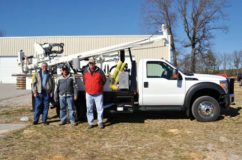 Members of Miracle Village, from the left, Doyne Robertson, Jamie Rivera and Tom Cone, stand in front of the group’s newly purchased well-digging rig. The rig will soon be sent to Peru.