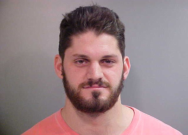 Austin Flynn, a defensive end for the Razorbacks' football team, was arrested Wednesday. 