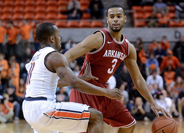 Auburn's Josh Wallace (11) defends Arkansas' Rickey Scott (3) during an NCAA college basketball game on Wednesday, Feb. 13, 2013, at Auburn Arena in Auburn, Ala. The Razorbacks beat the Tigers 83-75.(AP Photo/Al.com, Julie Bennett)