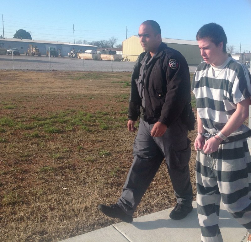 Zachary Holly being taken back to the Benton County Jail on Thursday after <a href="http://www.nwaonline.com/news/2013/feb/14/zachary-hollys-wife-gets-no-contact-order/?latest">a judge ordered him not to have any contact with his wife.</a>