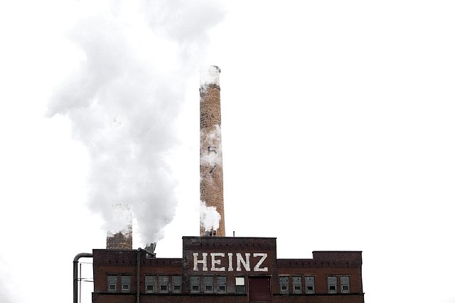 An H.J. Heinz Co. factory in Pittsburgh churns out products Thursday. The Heinz corporate headquarters is expected to remain in Pittsburgh after the company is sold. 