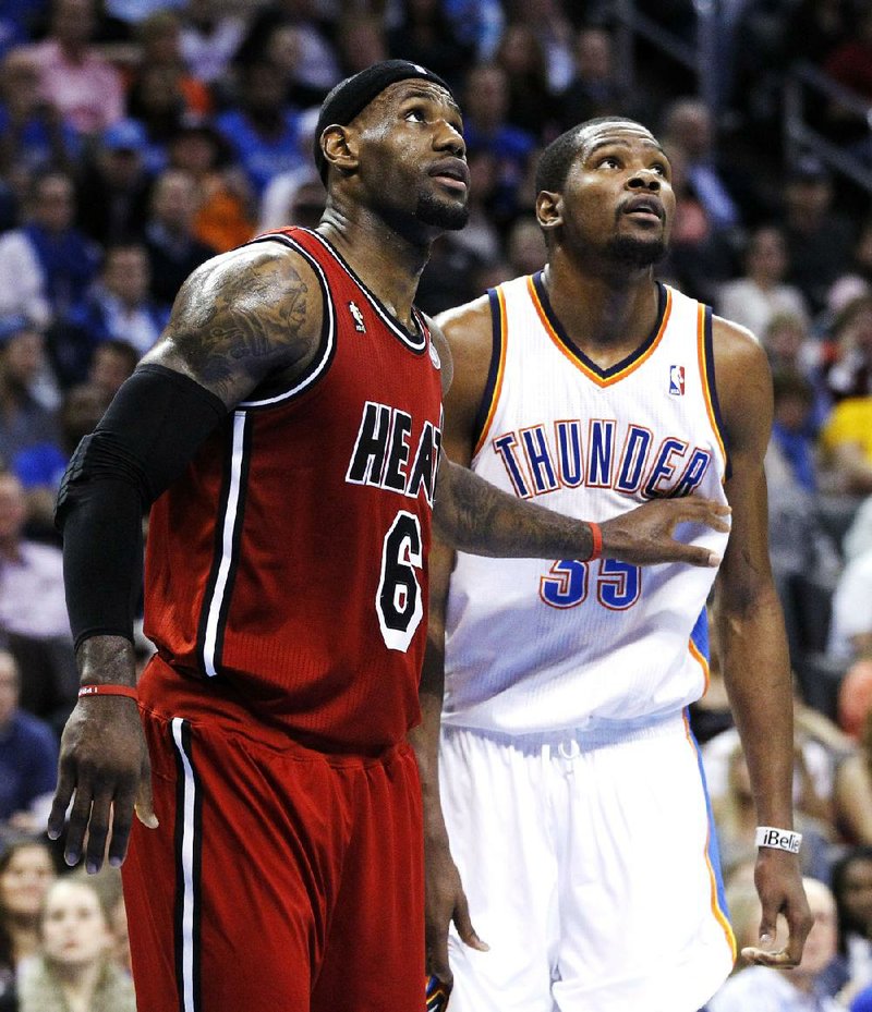 Miami Heat forward LeBron James (left) had 39 points, 12 rebounds and 7 assists to beat Kevin Durant (right) and the Oklahoma City Thunder 110-100 on Thursday night. 