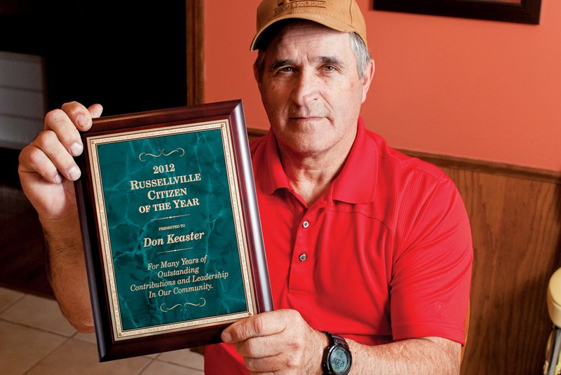 Don Keaster holds his 2012 Citizen of the Year plaque, presented by the Russellville Area Chamber of Commerce at its annual banquet. Keaster, who said he “had a bug” that night, attended because he thought his son was the one being honored.