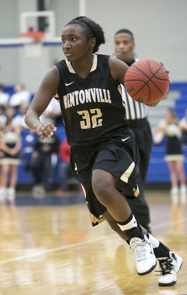 Jamayne Potts of Bentonville brings the ball up the court during Tuesday’s game against Rogers at Rogers High. 