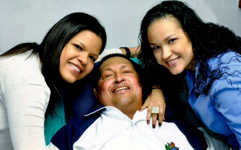In this photo released Friday, Feb. 15, 2013, by Miraflores Presidential Press Office, Venezuela's President Hugo Chavez, center, poses for a photo with his daughters, Maria Gabriela, left, and Rosa Virginia at an unknown location in Havana, Cuba, on Thursday, Feb. 14, 2013. 