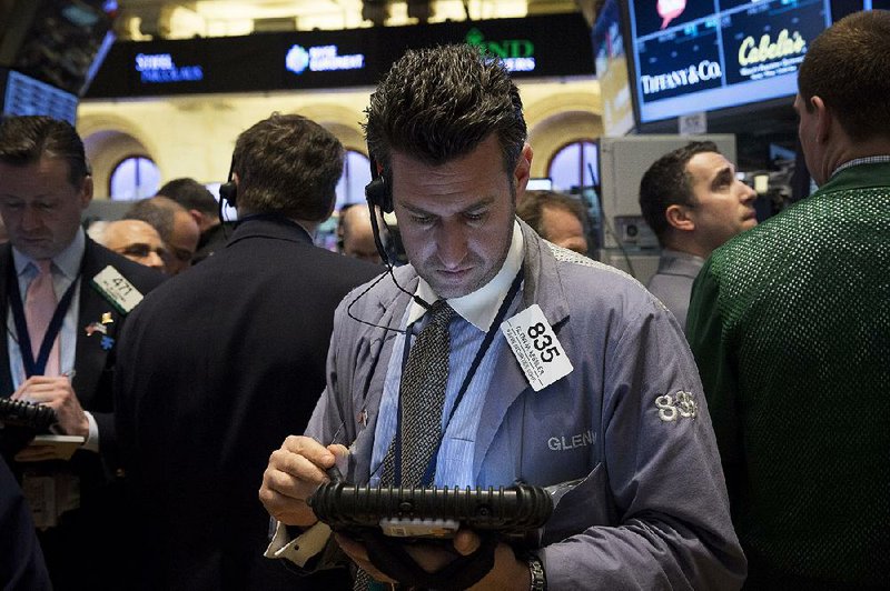 Glen Kessler, a trader with Raven Securities Corp., works Friday on the floor of the New York Stock Exchange. The stock indexes ended the week with a day of slight losses. 