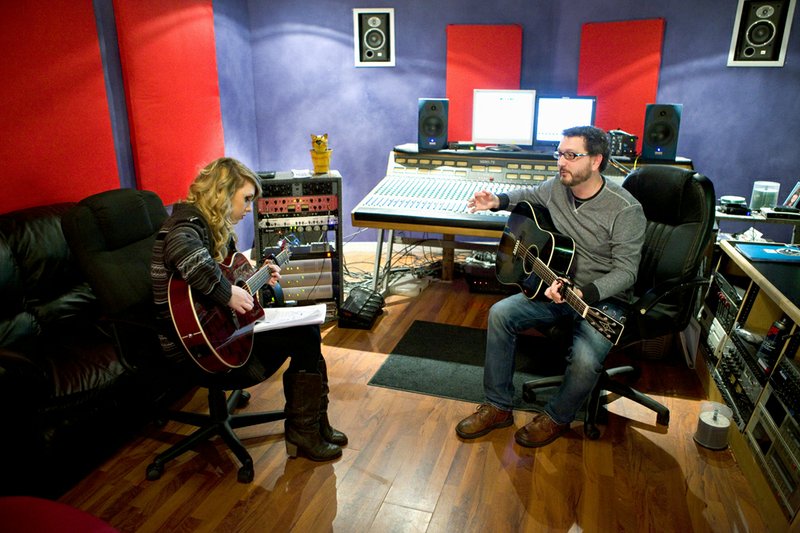 Crystal Gray, left, works on arranging one of her songs with Darian Stribling at Blue Chair Recording Studio in Austin. Gray is an aspiring musician who regularly works with Stribling to develop her musical abilities.