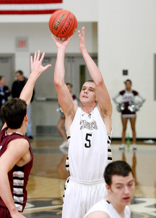 Nick Smith, a Bentonville senior, puts up a shot over Siloam Springs senior Payton Henson during the first half on Friday at Bentonville. 