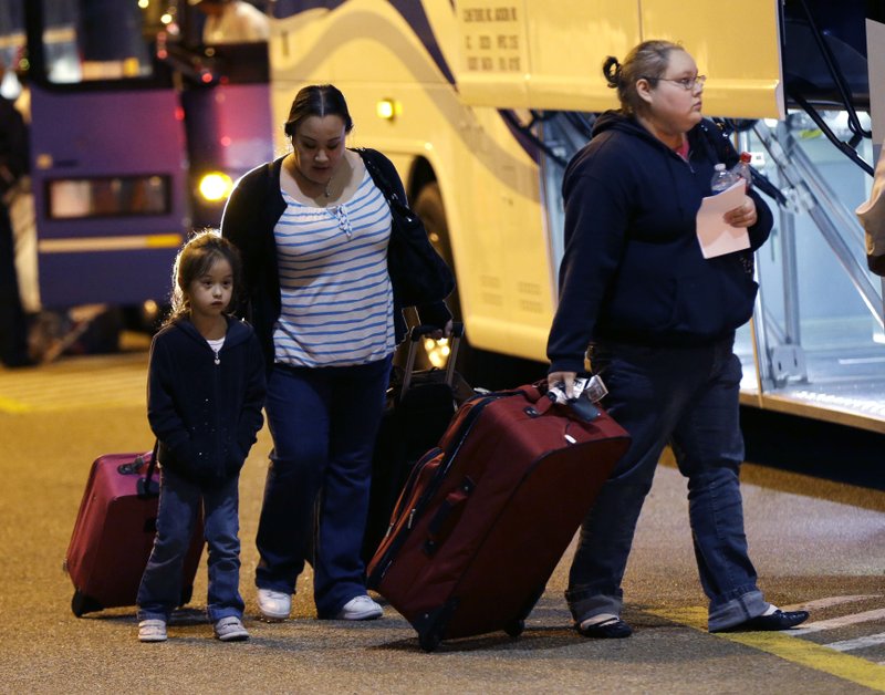 Passengers from the disabled Carnival Triumph cruise ship arrive by bus at the Hilton Riverside Hotel in New Orleans, Friday, Feb. 15, 2013. The ship had been idled for nearly a week in the Gulf of Mexico following an engine room fire.