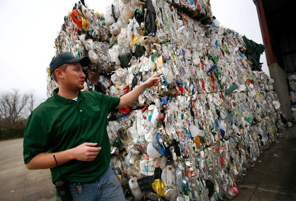 Kyle McCarty with Fayetteville Solid Waste and Recycling Division talks about the bales of No. 3 through 7 plastics Feb. 7 at the recycling drop-off facility. The city will no longer accept these plastics while they look for a buyer. 